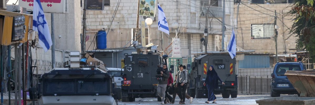 Israeli forces in armored vehicles conduct a raid in Jenin.