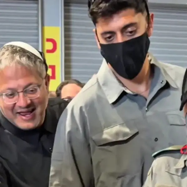 Israeli National Security Minister Itamar Ben-Gvir smiles as a flotilla activist is humiliated