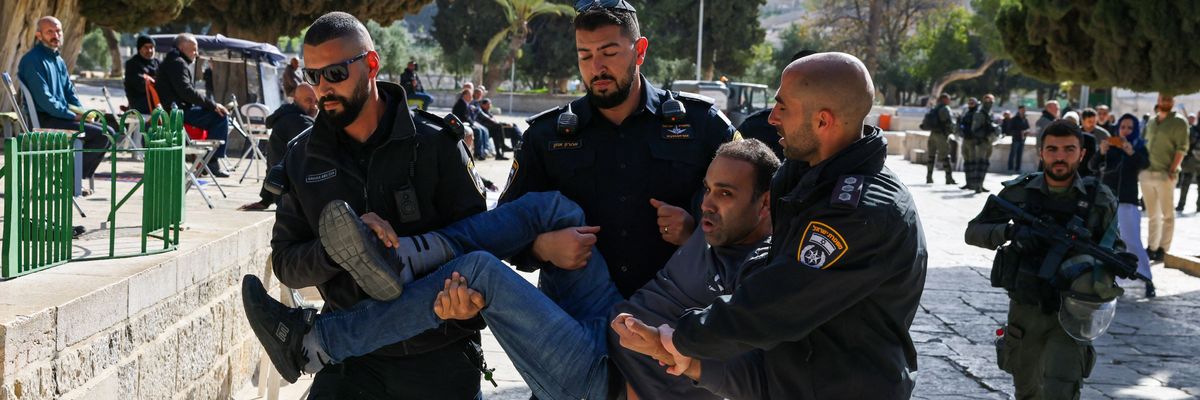 Israeli police officers detain a Palestinian man at the Al-Aqsa Mosque compound following a raid on the holy site in occupied East Jerusalem on April 5, 2023.
