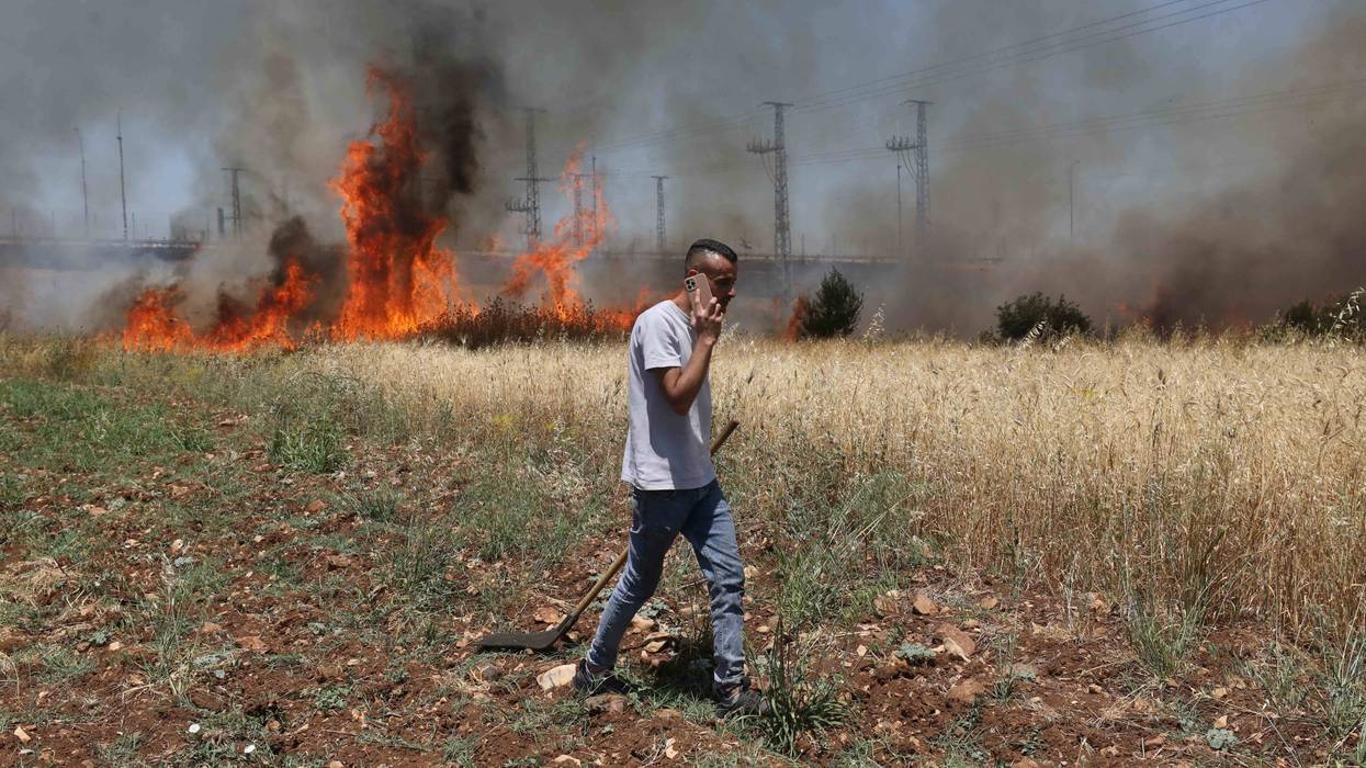 Israeli settlers set fire to Palestinians' agricultural fields in the West Bank