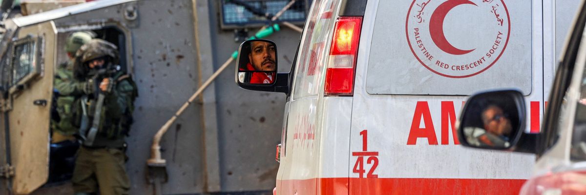 Israeli troops stop and point a gun at West Bank ambulances