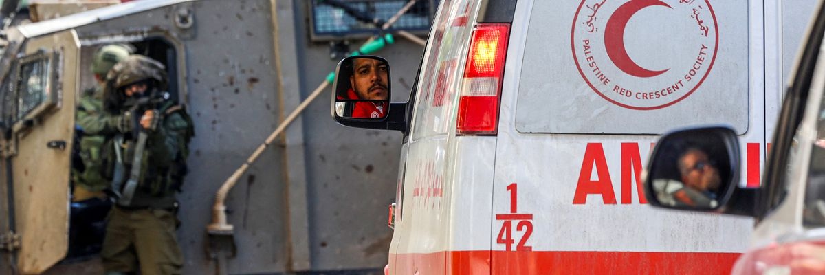 Israeli troops stop and point a gun at West Bank ambulances