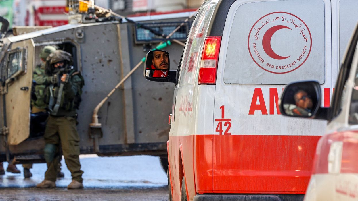 Israeli troops stop and point a gun at West Bank ambulances