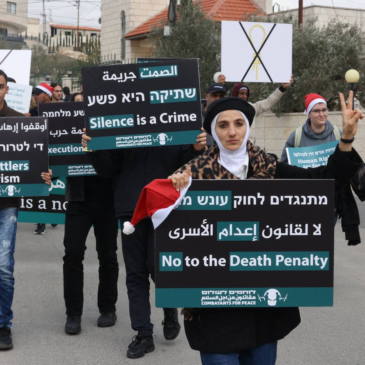 Israelis, Palestinians, and other people march in Bethlehem against the proposed Israeli death penalty bill