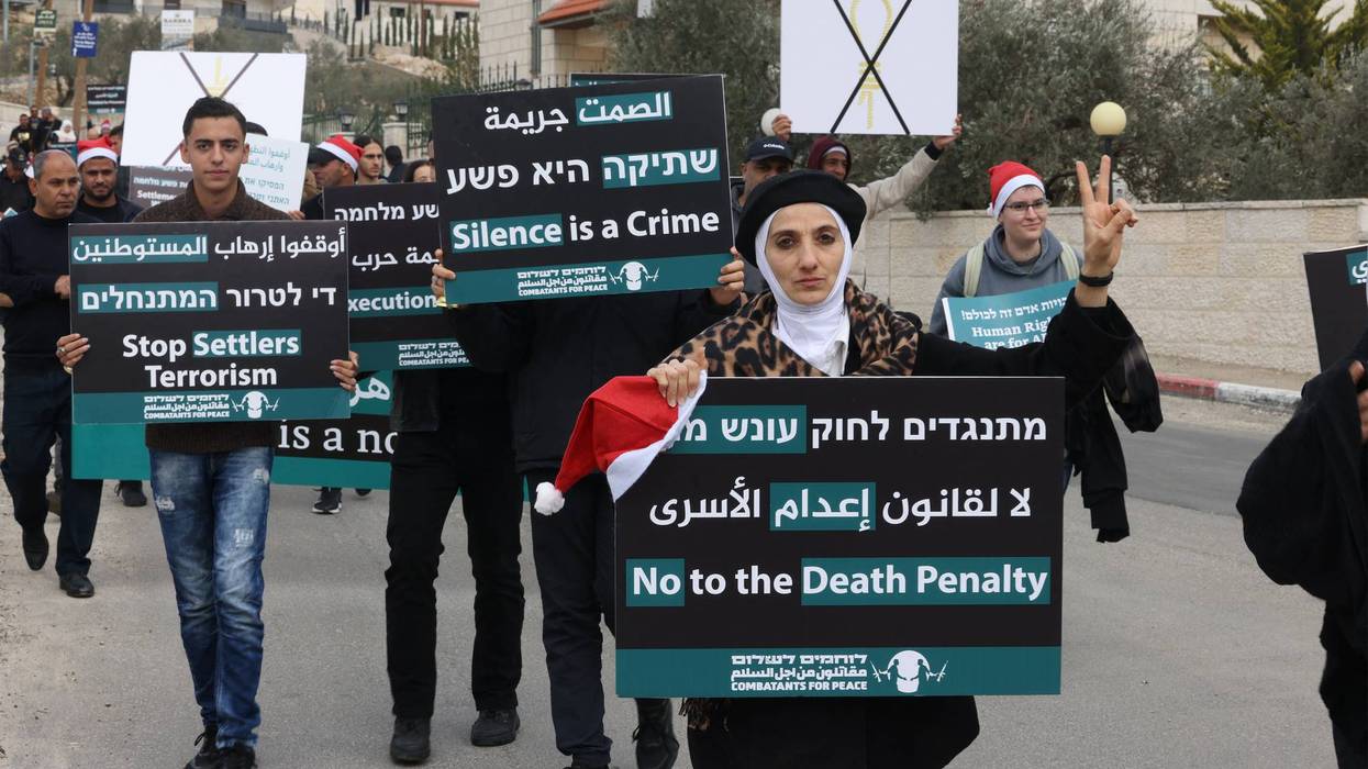 Israelis, Palestinians, and other people march in Bethlehem against the proposed Israeli death penalty bill