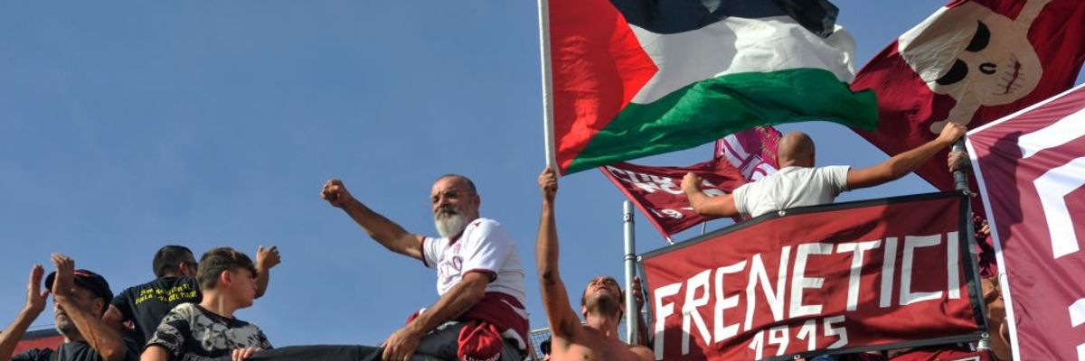 Italian football fans wave a Palestinian flag