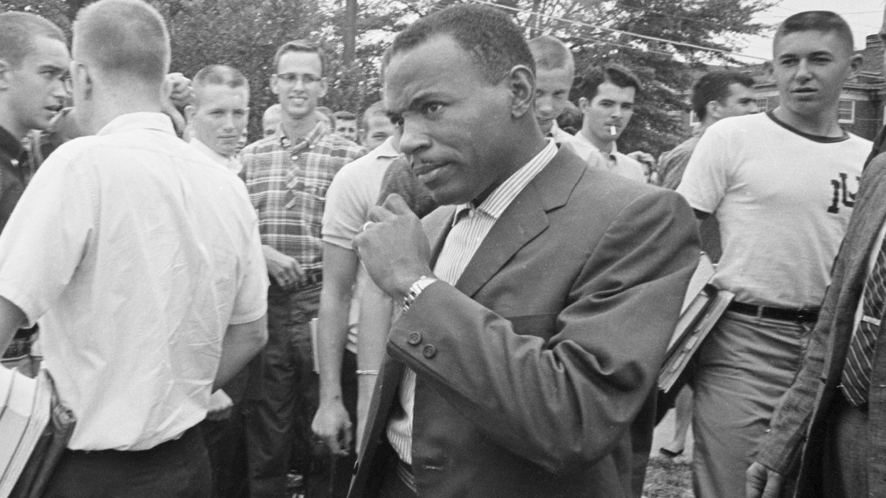 James Meredith walks across the Ole Miss campus amidst stares and jeers of white fellow students.