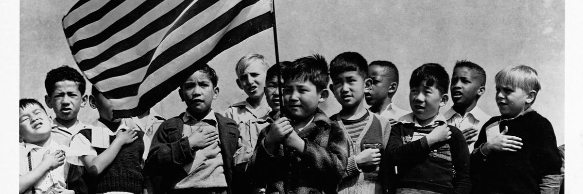 Japanese Americans join other kids to say the Pledge of Allegiance days before they are placed in interntment camps during World War ll.