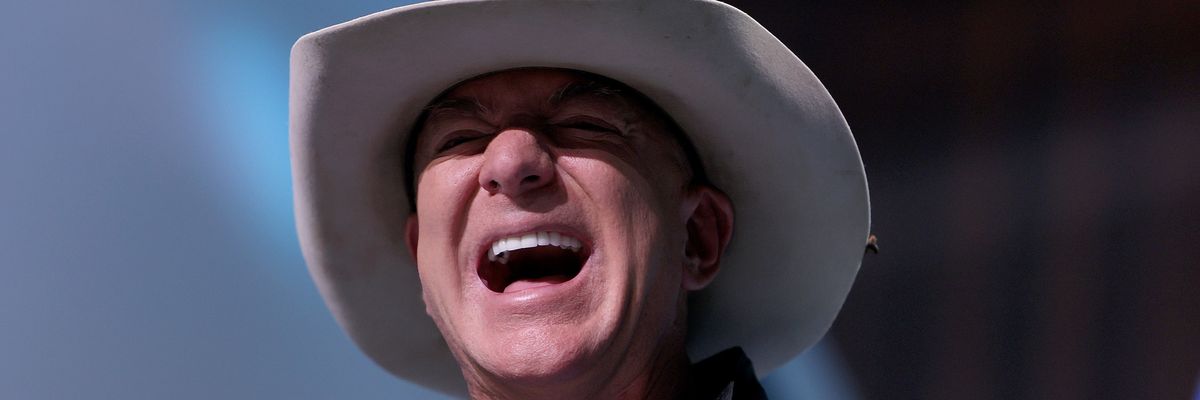 Jeff Bezos laughs in a cowboy hat.