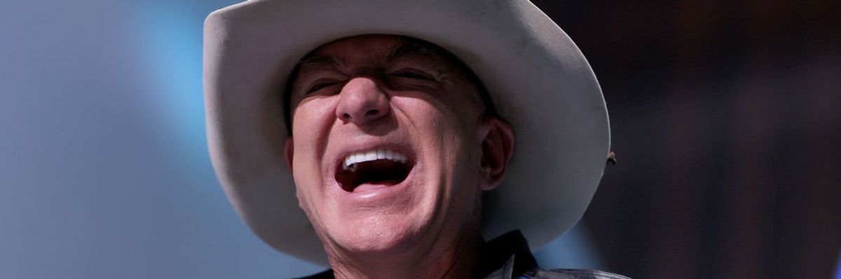 Jeff Bezos laughs in cowboy hat