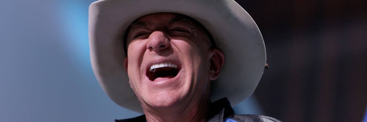 Jeff Bezos laughs.