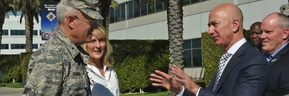 Jeff Bezos speaks with a U.S. general