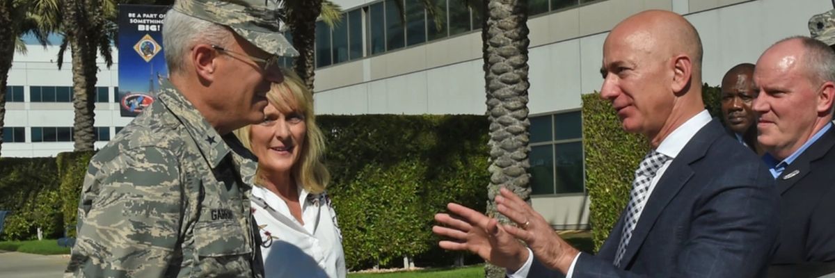 Jeff Bezos speaks with a U.S. general