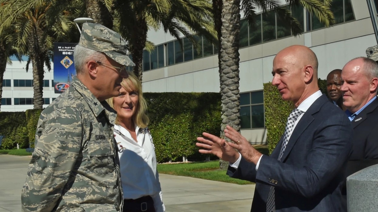Jeff Bezos speaks with a U.S. general