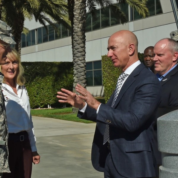 Jeff Bezos speaks with a U.S. general
