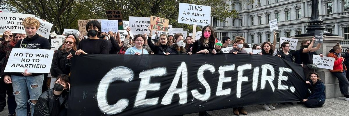 Jewish-led peace activists hold a "ceasefire" banner outside the White House.