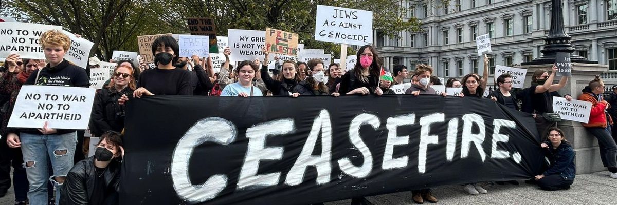 Jewish-led peace activists hold a "ceasefire" banner outside the White House. 