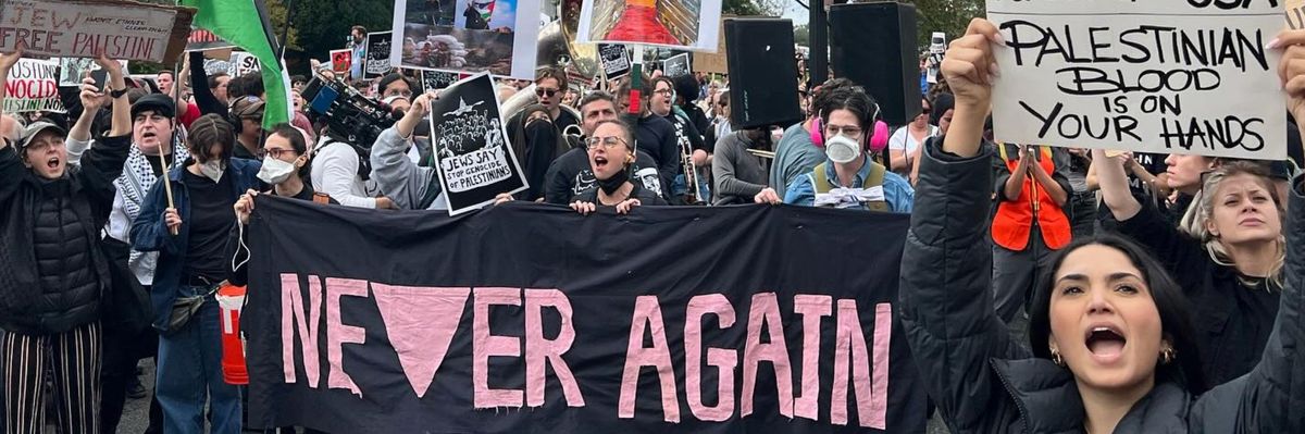 Jewish-led protesters with a banner reading "never again" rally near the U.S. Capitol