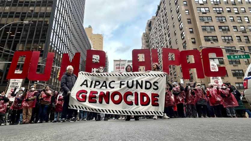 Jewish protesters in NYC hold a banner reading, "AIPAC funds genocide"