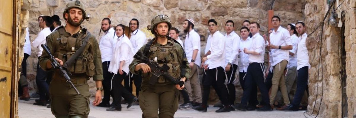 Jewish settlers march around old town in Hebron