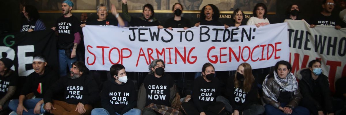 Jewish Voice for Peace activists hold a banner reading, "Jews to Biden: Stop Arming Genocide."