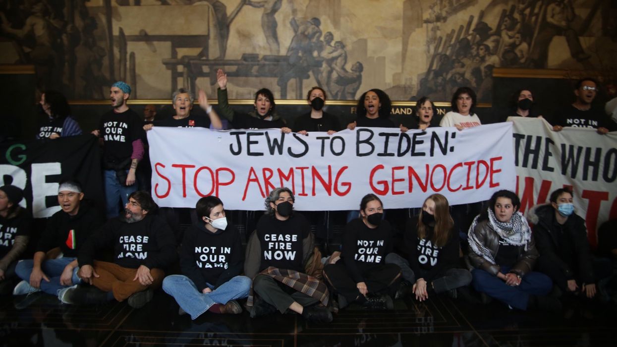 Jewish Voice for Peace activists hold a banner reading, "Jews to Biden: Stop Arming Genocide."