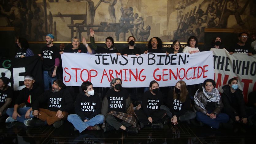 Jewish Voice for Peace activists hold a banner reading, "Jews to Biden: Stop Arming Genocide."