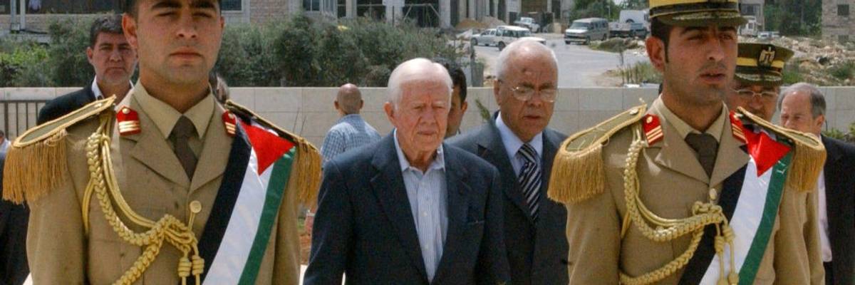 Jimmy Carter prepares to place a wreath at the tomb of Yaser Arafat