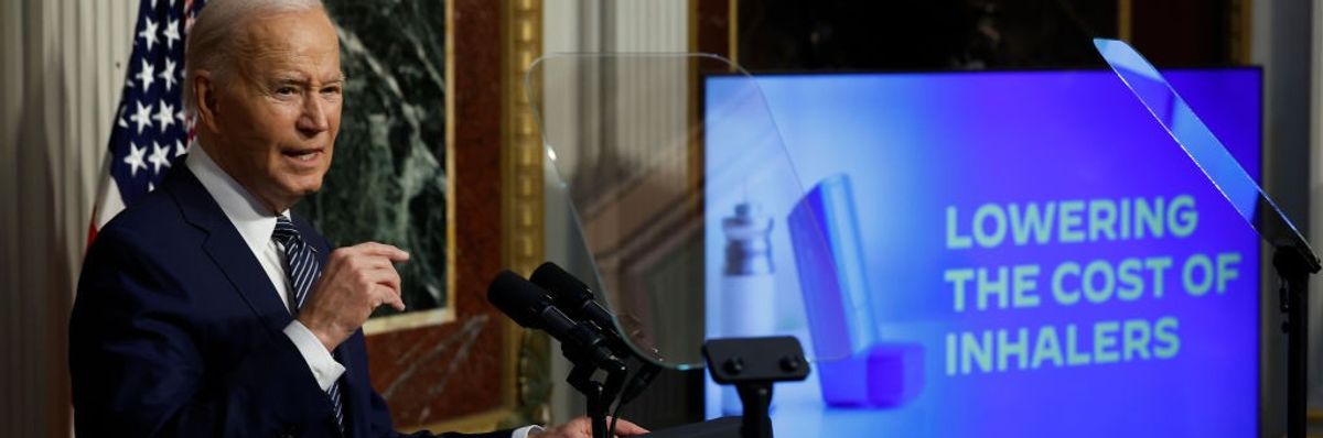 Joe Biden and a sign "lowering the cost of inhalers"