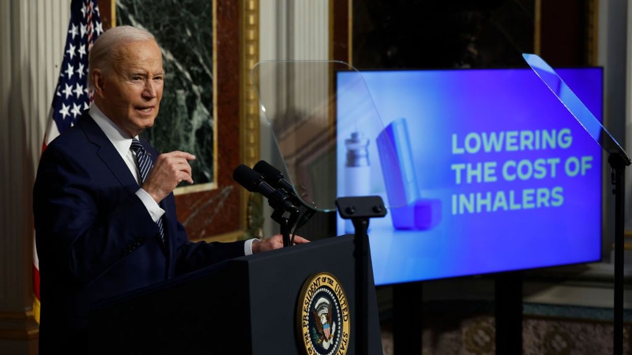 Joe Biden and a sign "lowering the cost of inhalers"