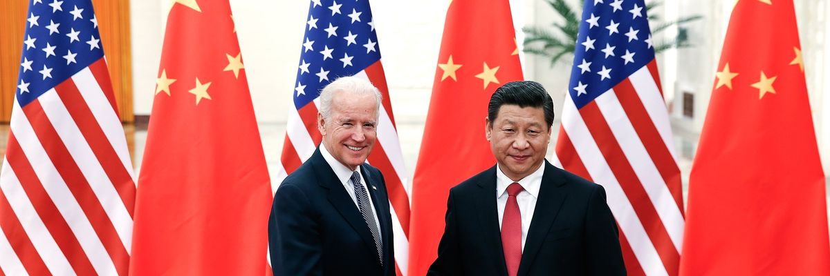 Joe Biden shakes hands with Xi Jinping