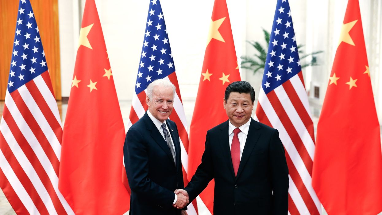 Joe Biden shakes hands with Xi Jinping