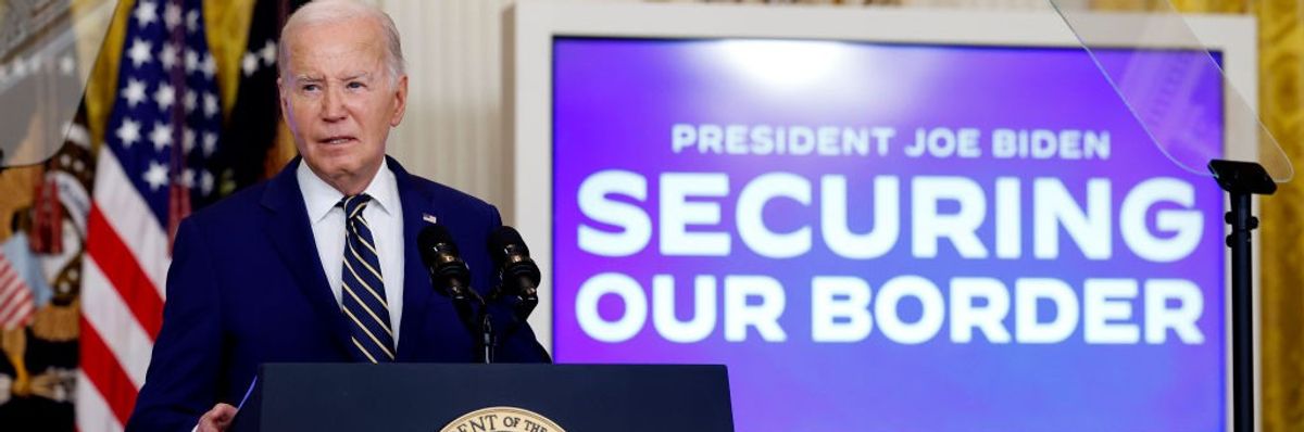 Joe Biden speaks at the presidential podium next to a sign reading "Securing Our Border"