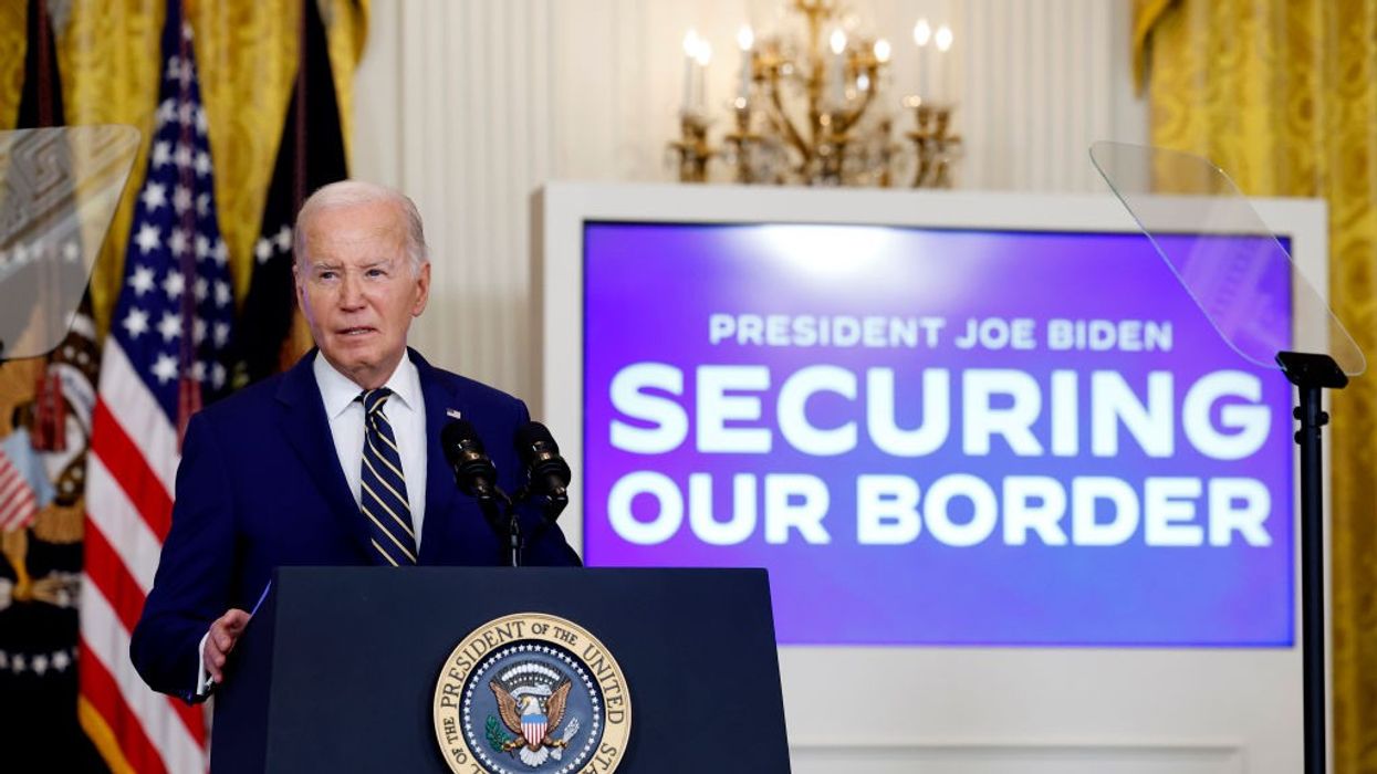 Joe Biden speaks at the presidential podium next to a sign reading "Securing Our Border"