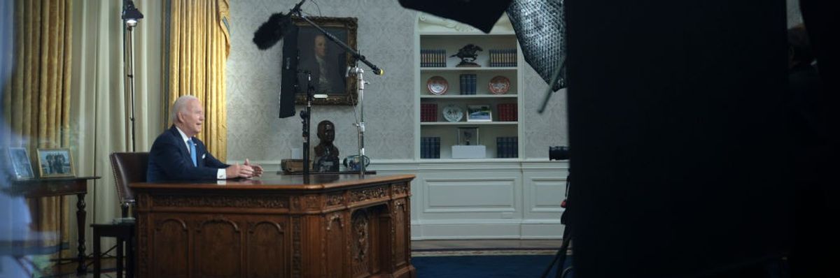 Joe Biden speaks from a desk.