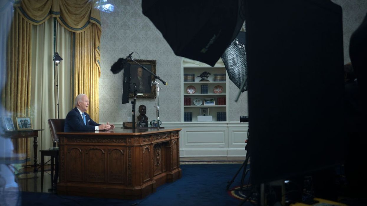 Joe Biden speaks from a desk.