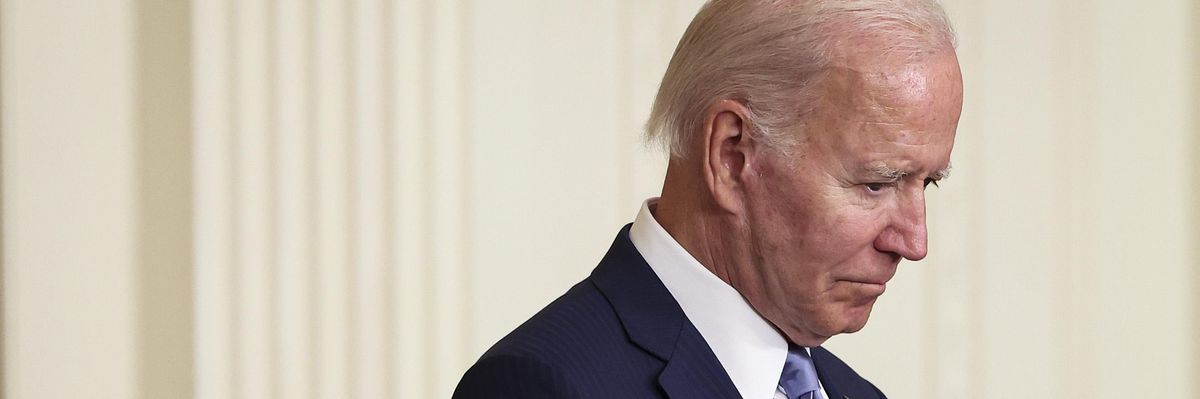 Joe Biden with his head bowed.