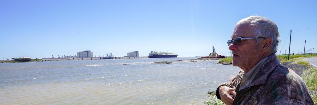 John Allaire stands in profile with water and LNG infrastructure in the background.