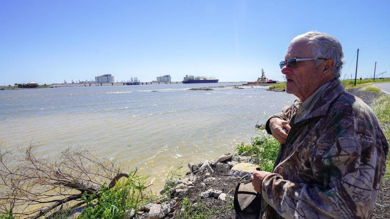 John Allaire stands in profile with water and LNG infrastructure in the background.
