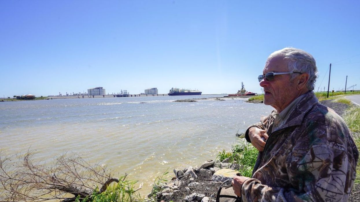 John Allaire stands in profile with water and LNG infrastructure in the background.