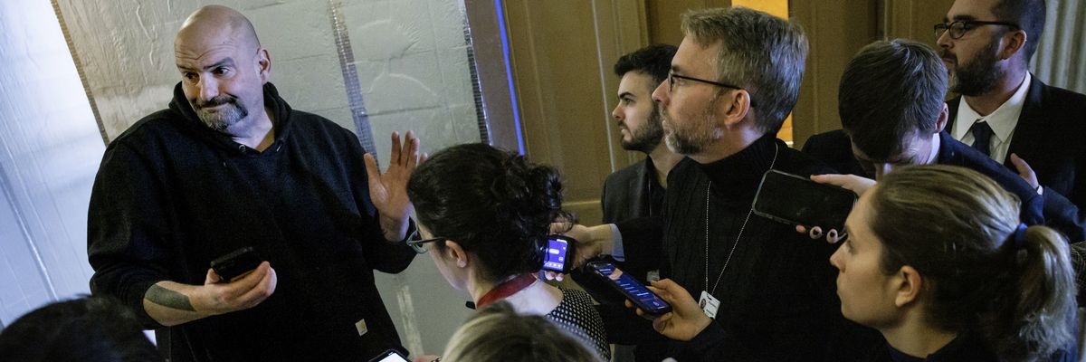John Fetterman talks to reporters.