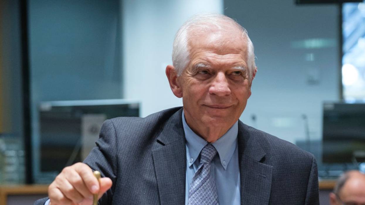 Josep Borrell rings a small bell to open an informal meeting of E.U. foreign ministers in Brussels.