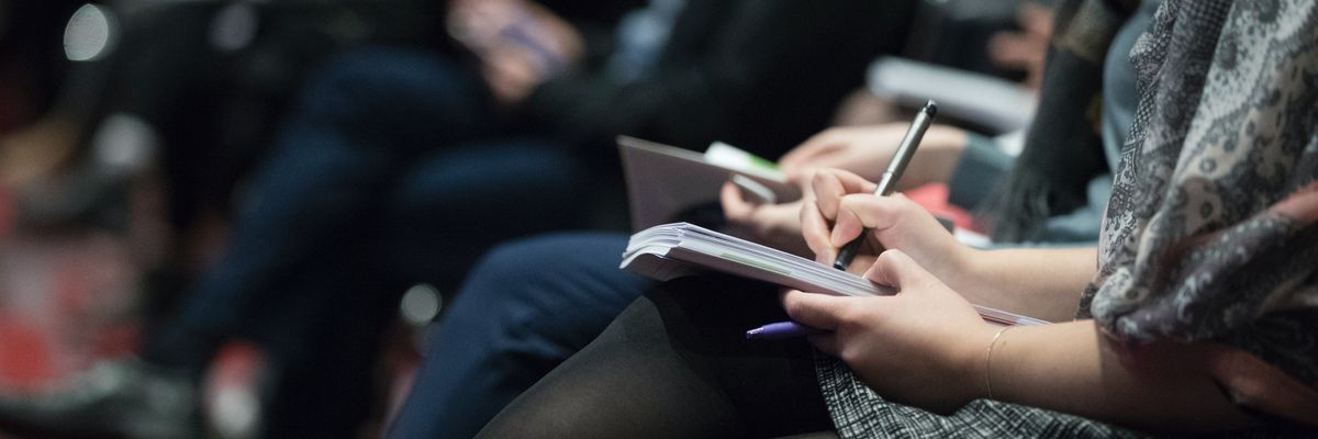 Journalists writing in notebooks