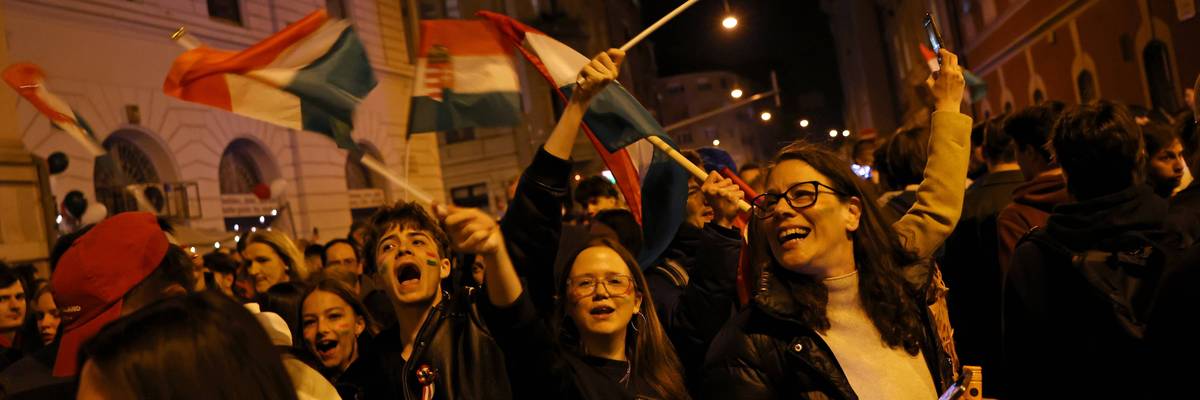 Jubilant Hungarians wave flags and celebrate the election results