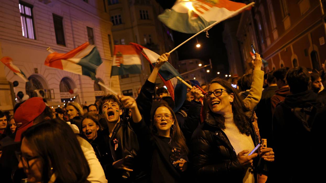 Jubilant Hungarians wave flags and celebrate the election results