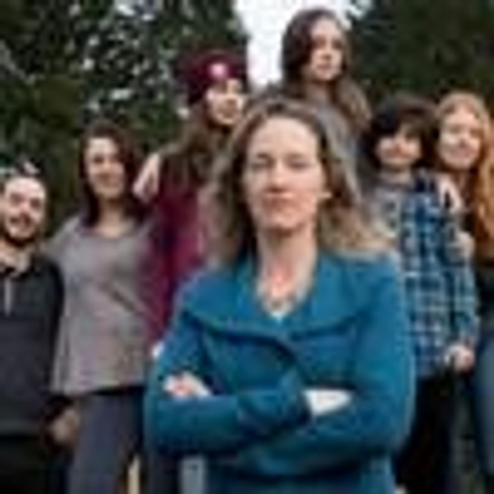 Julia Olson, executive director and chief legal counsel at Our Children's Trust, stands with some of the youth plaintiffs from the landmark lawsuit <em>Juliana v. United States</em>. (Photo: courtesy of Robin Loznak)