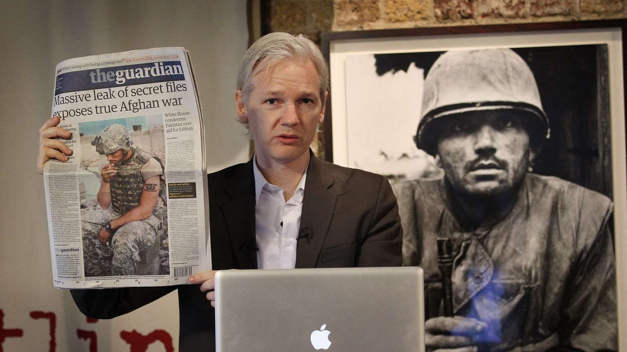 Julian Assange of the WikiLeaks website holds up a copy of The Guardian newspaper