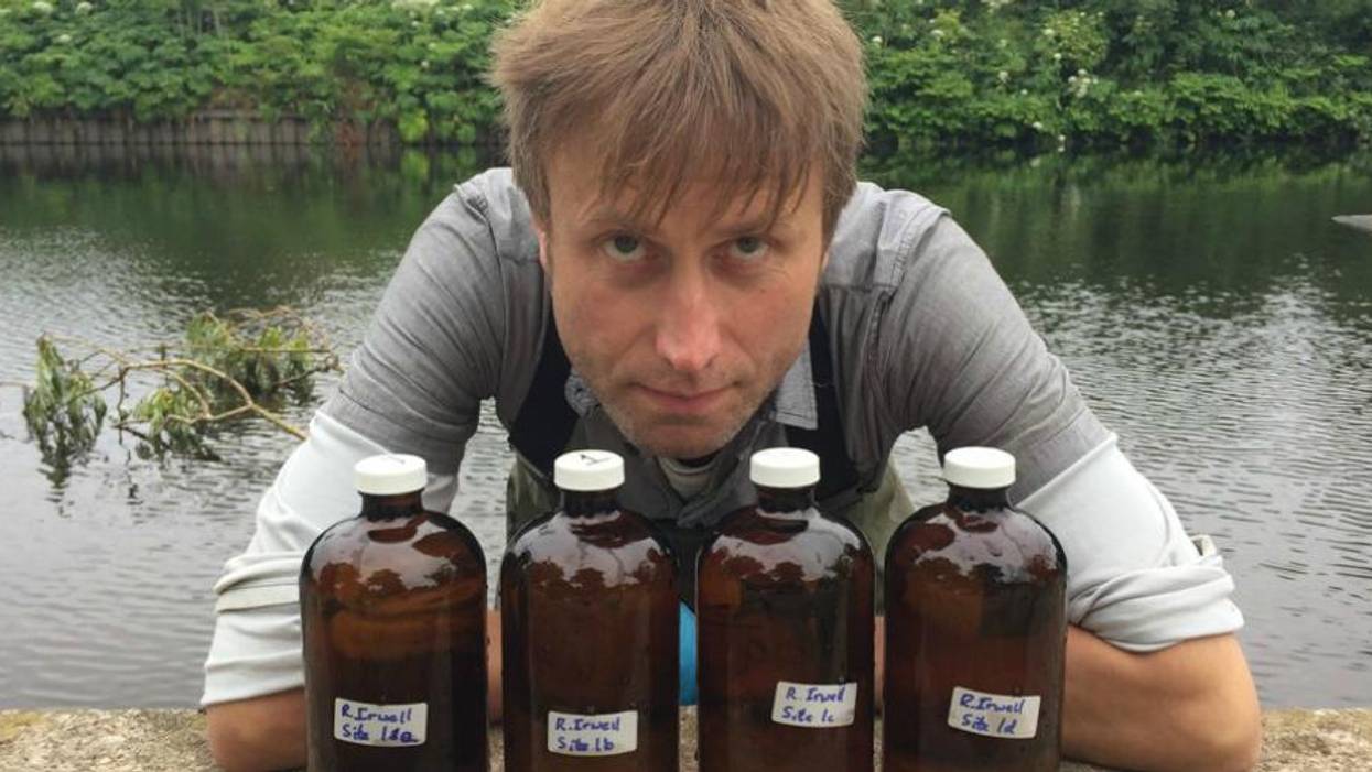 Julian Kirby, a researcher and plastics campaigner at Friends of the Earth, poses with bottles containing water samples from with River Irwell in the United Kingdom