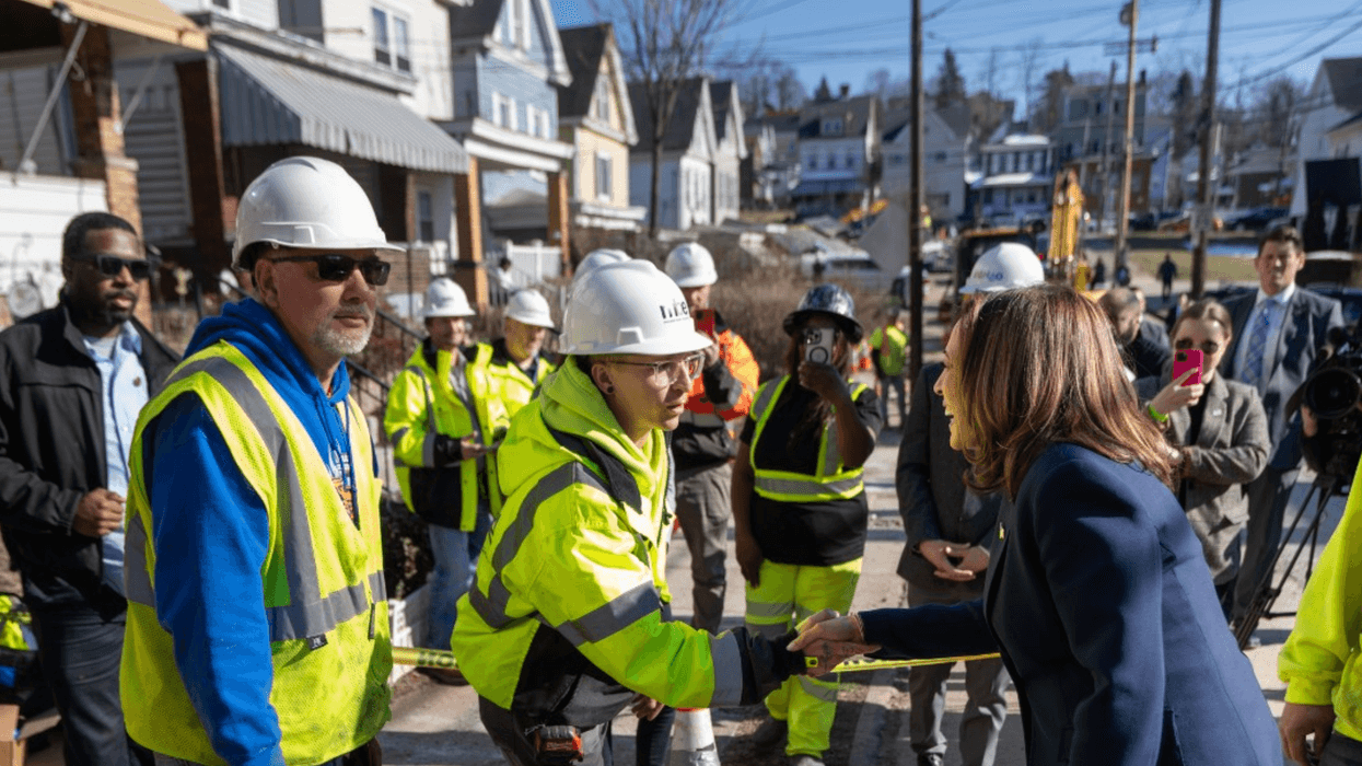 Kamala Harris shakes hands with a unionized worker