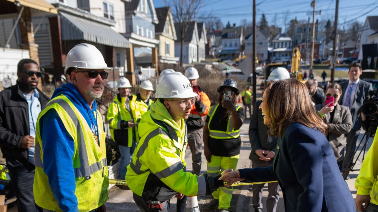 Kamala Harris shakes hands with a unionized worker